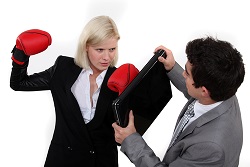 angry woman confronting a man with a lap top computer